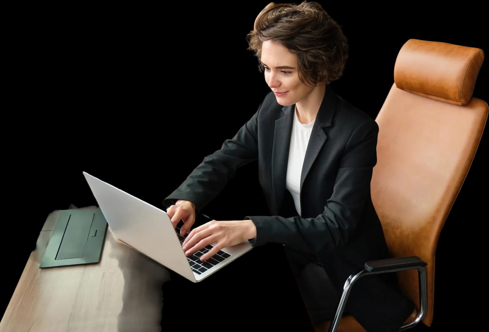An employee typing at her laptop in a tan office chair